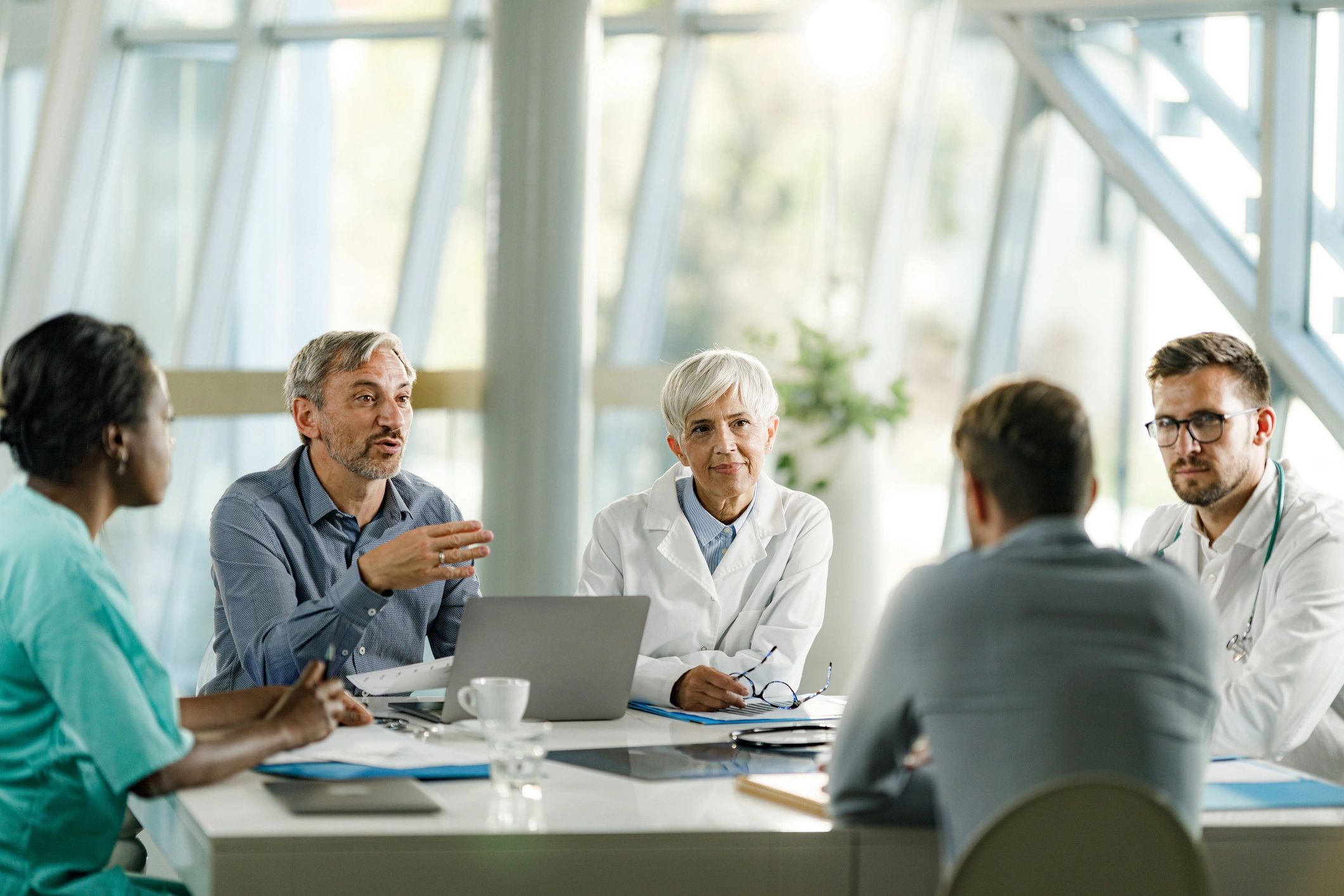 Healthcare leaders meeting to review compliance documentation